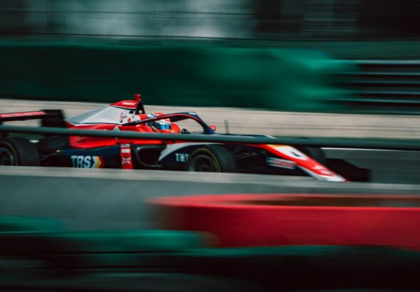 a man driving a race car on a track