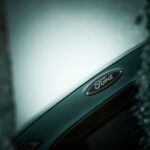 Close-up of a ford car emblem on a dark background