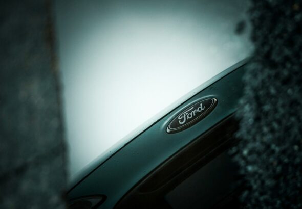 Close-up of a ford car emblem on a dark background