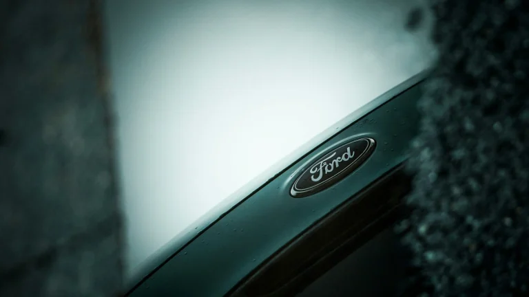 Close-up of a ford car emblem on a dark background