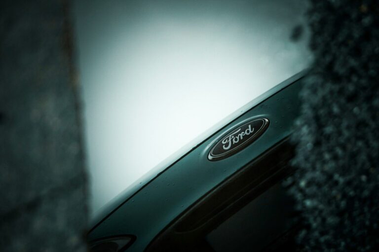 Close-up of a ford car emblem on a dark background