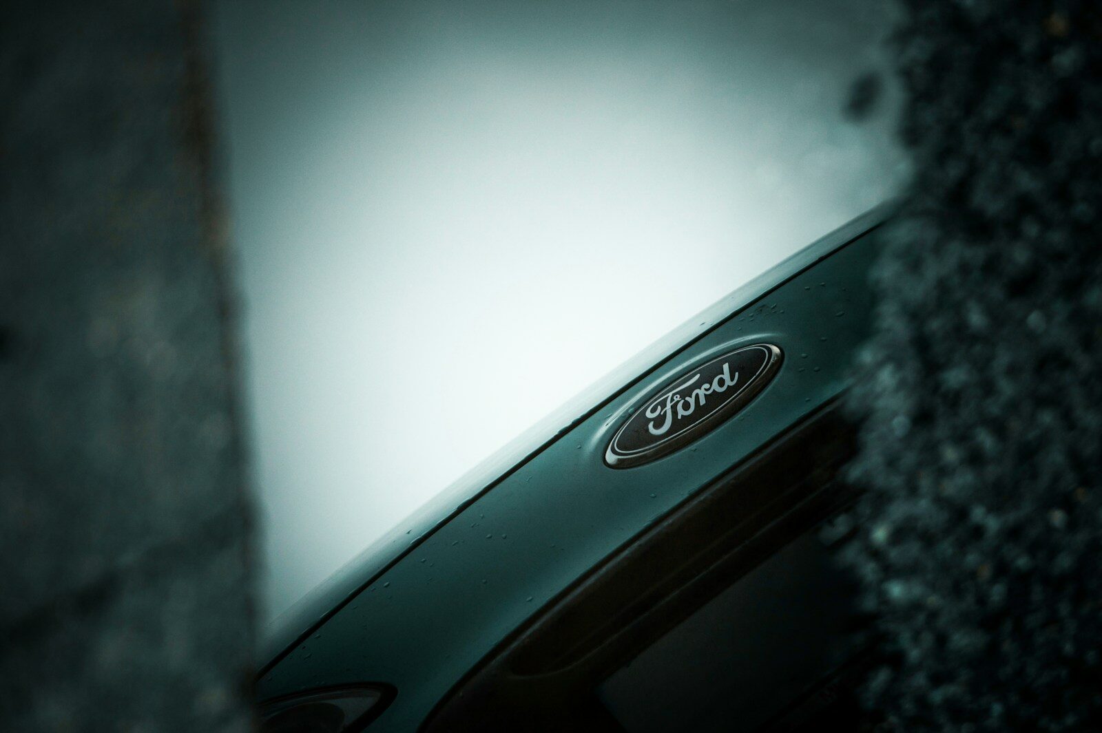 Close-up of a ford car emblem on a dark background