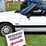 White 1990 Ford Mustang LX 5.0 convertible with the top down, side profile