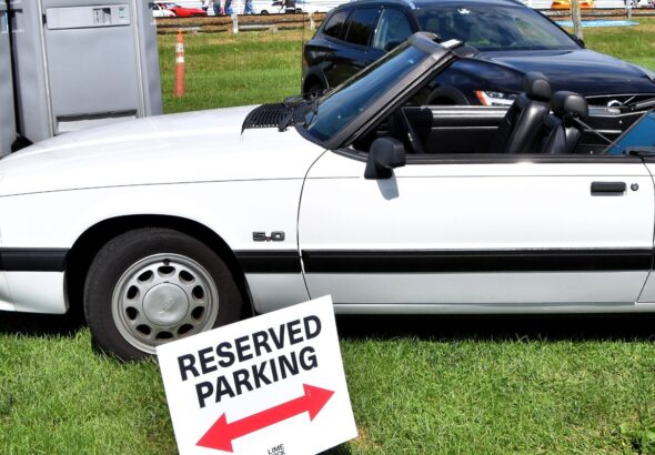 White 1990 Ford Mustang LX 5.0 convertible with the top down, side profile