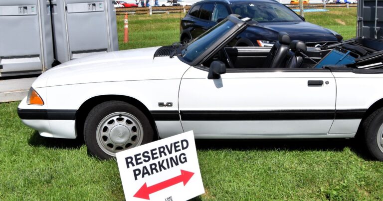 White 1990 Ford Mustang LX 5.0 convertible with the top down, side profile