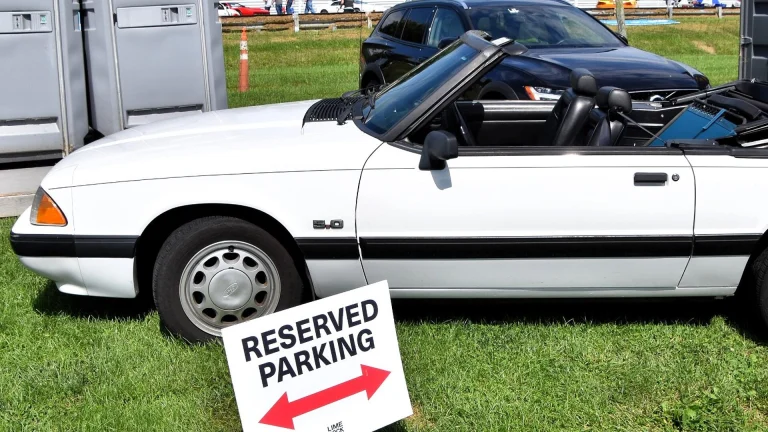 White 1990 Ford Mustang LX 5.0 convertible with the top down, side profile