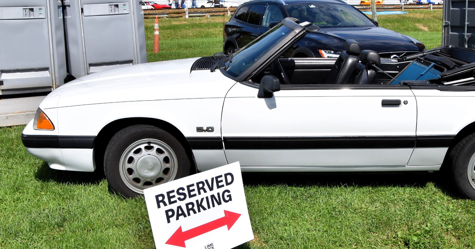 White 1990 Ford Mustang LX 5.0 convertible with the top down, side profile