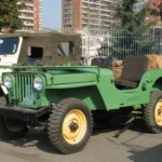 Green 1946 Willys CJ-2A with yellow wheels, the civilian Jeep that inspired the 2027 Wrangler JL-2A