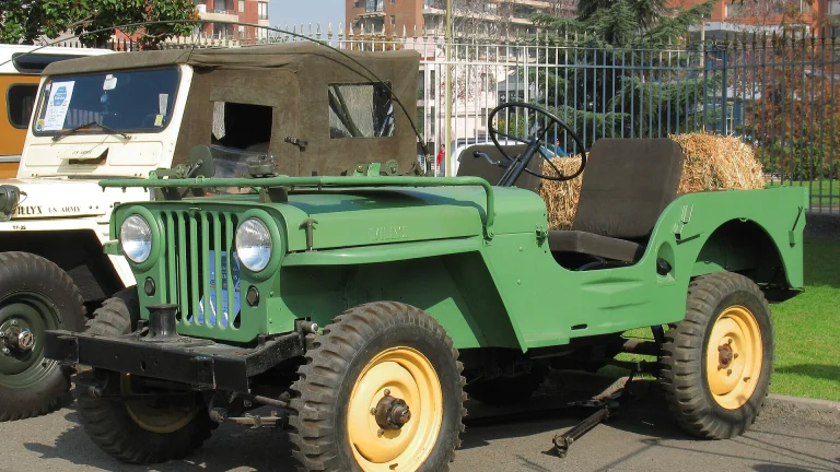Green 1946 Willys CJ-2A with yellow wheels, the civilian Jeep that inspired the 2027 Wrangler JL-2A