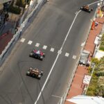 Formula 1 cars racing through the Monaco Grand Prix street circuit pit straight