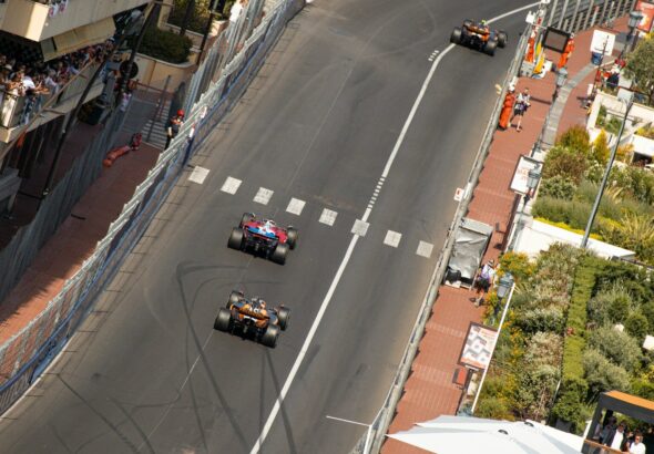 Formula 1 cars racing through the Monaco Grand Prix street circuit pit straight