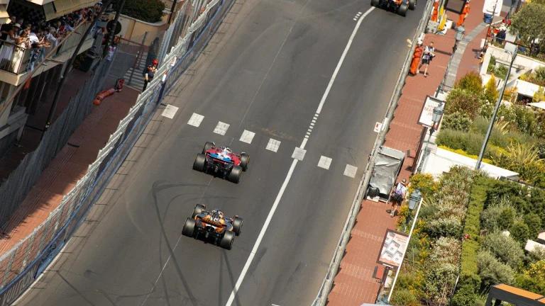 Formula 1 cars racing through the Monaco Grand Prix street circuit pit straight
