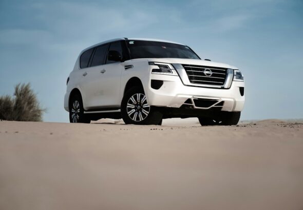 2027 Nissan Patrol Y63 white SUV front three-quarter in desert