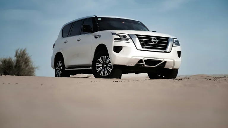 2027 Nissan Patrol Y63 white SUV front three-quarter in desert