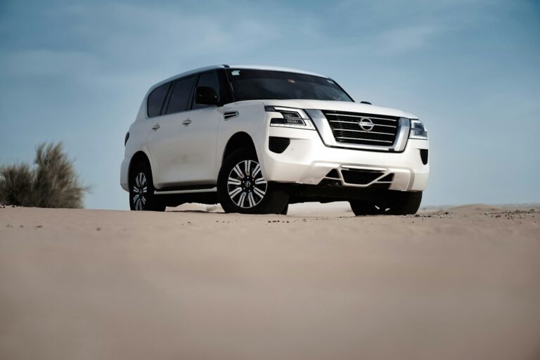 2027 Nissan Patrol Y63 white SUV front three-quarter in desert