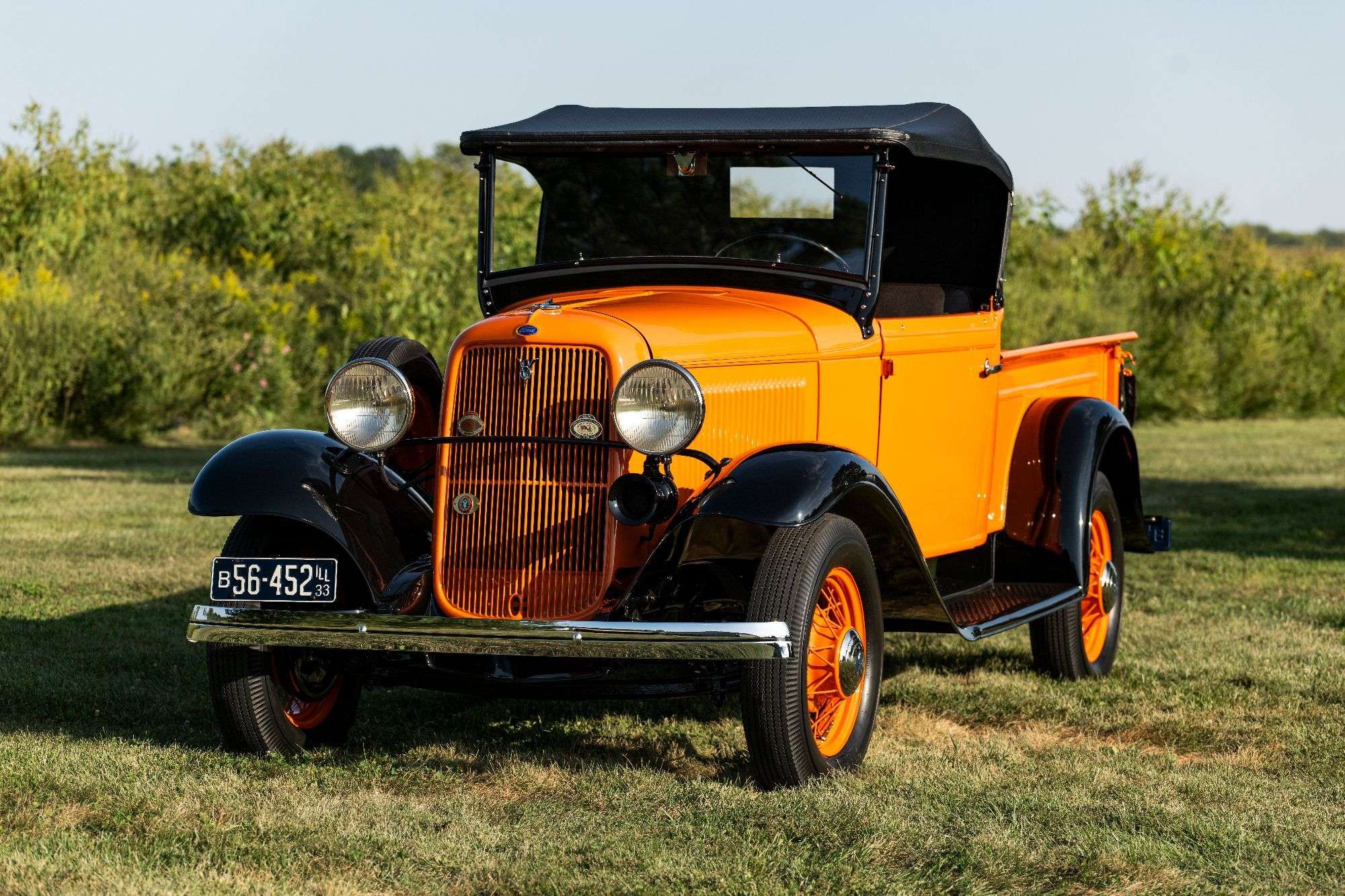 Front three-quarter view of the 1933 Ford V8 Roadster Pickup with its black fenders and wire wheels