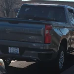 Gray 2021 Chevrolet Silverado 1500 RST crew cab parked on a street, rear three-quarter view