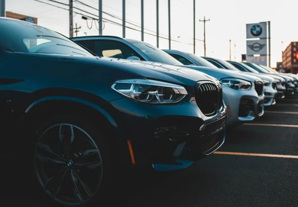 a row of cars parked in a parking lot