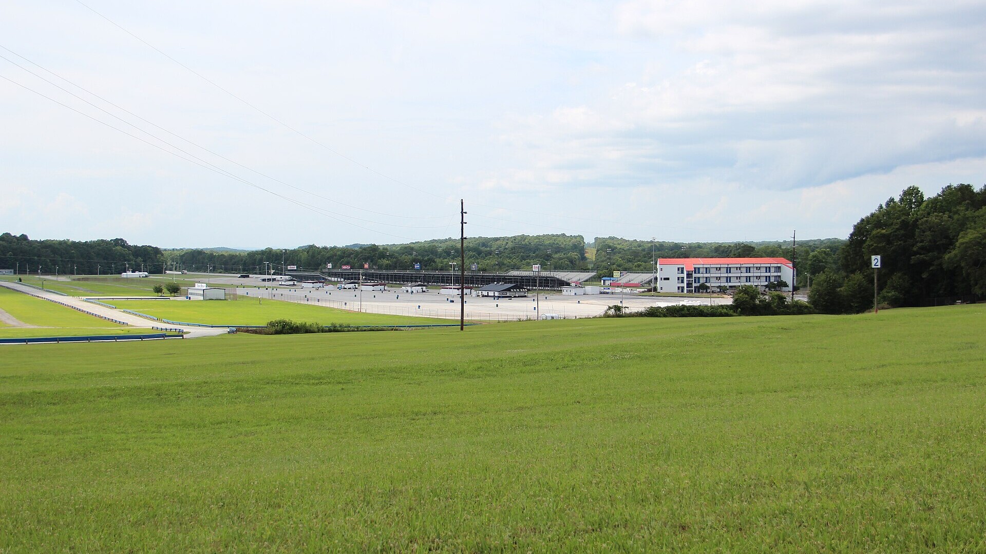 Atlanta Dragway grandstands and tower seen across a grassy field in Commerce, Georgia