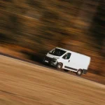 a white car driving on a road