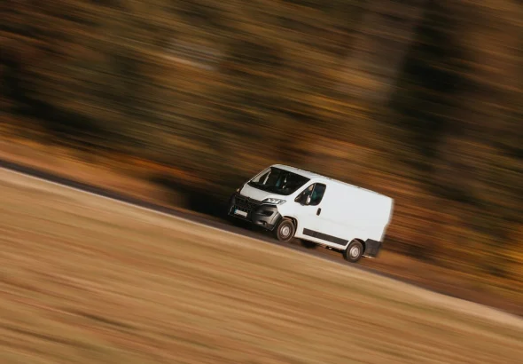 a white car driving on a road