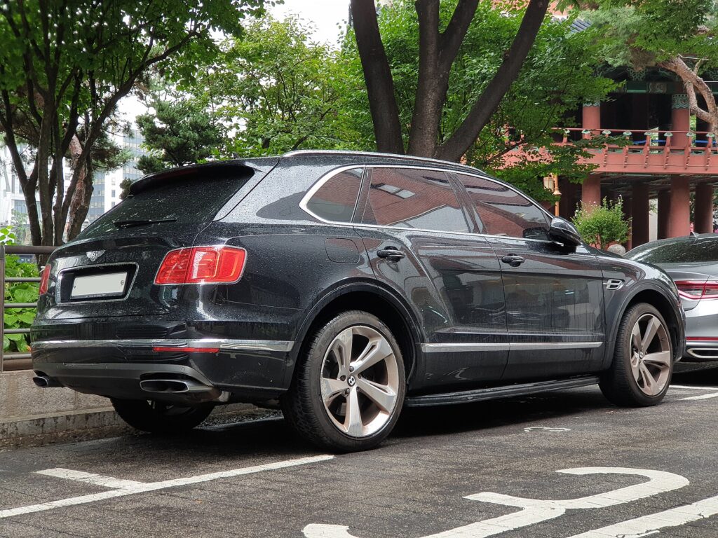 A black Bentley Bentayga parked on a street