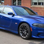 Indigo Blue 2021 Dodge Charger Scat Pack seen from the front right at a car show