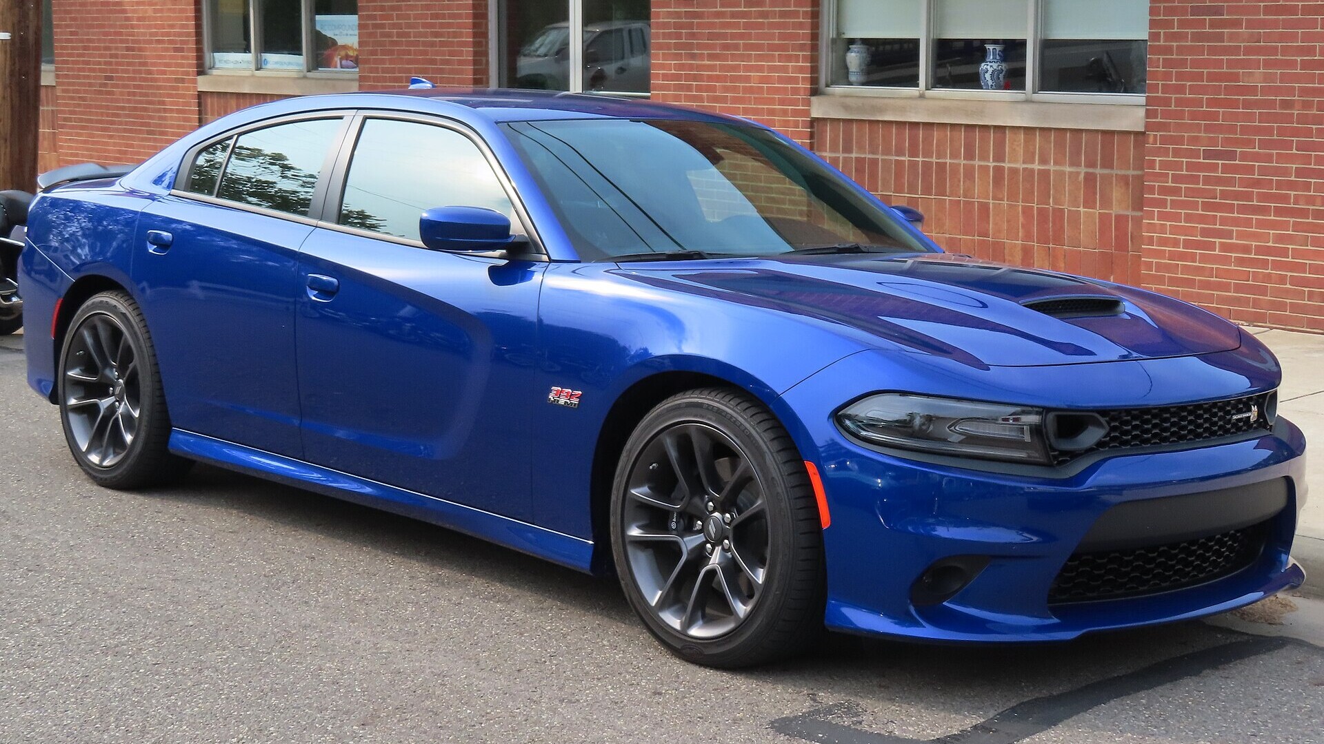 Indigo Blue 2021 Dodge Charger Scat Pack seen from the front right at a car show