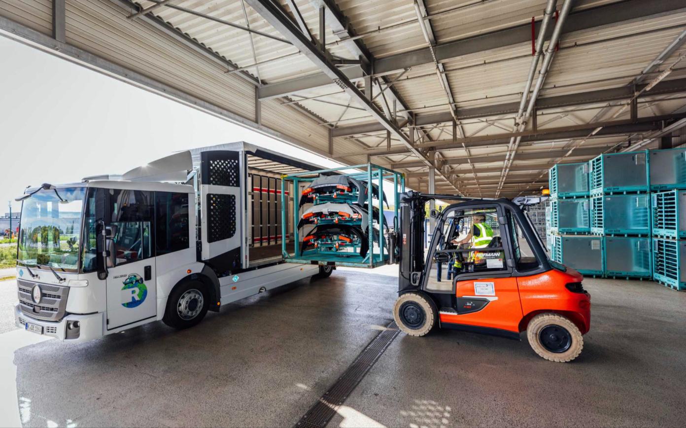 Forklift loading a rack of bumper covers into BMW's hydrogen combustion truck at Plant Leipzig