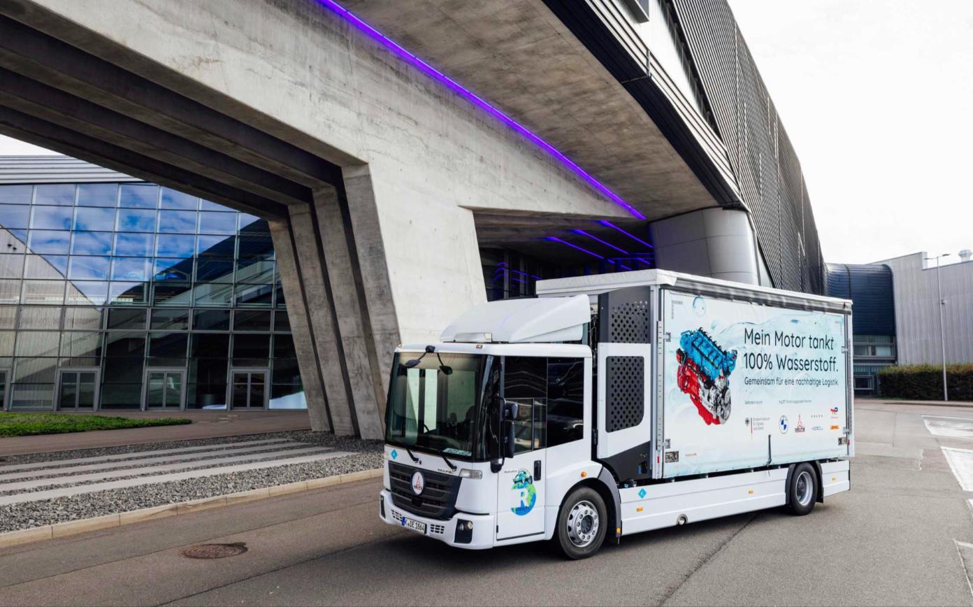 BMW HyCET hydrogen combustion truck parked at Plant Leipzig with partner logos on its curtain side