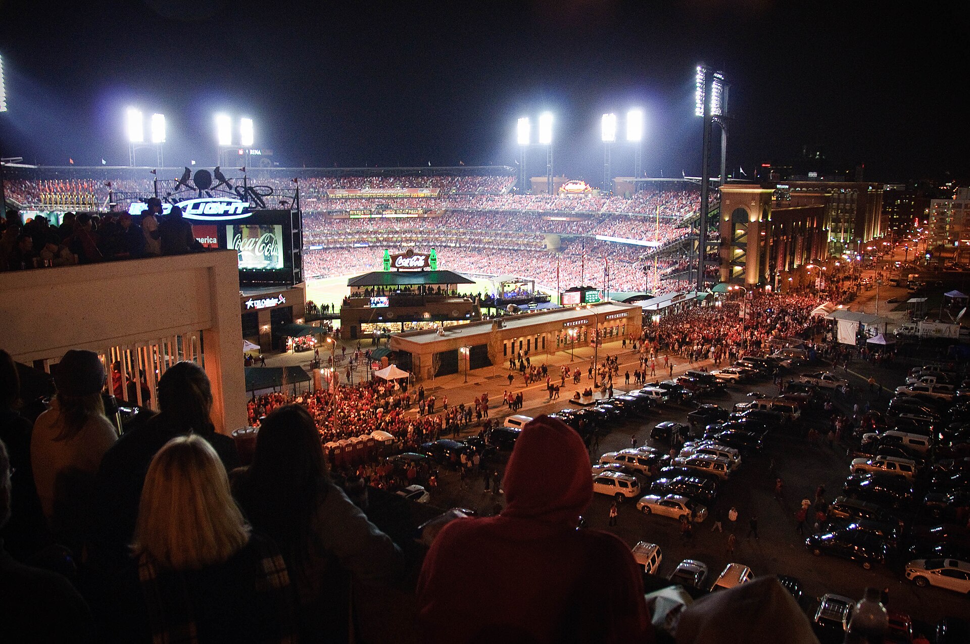 Busch Stadium lit at night with downtown St. Louis streets below