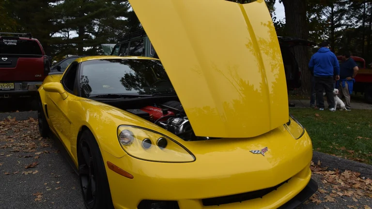 Yellow C6-generation Chevrolet Corvette coupe with its hood open