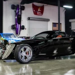 Black 2006 Foose Hemisfear hot rod coupe on display
