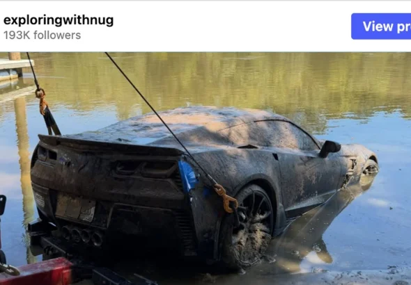 Mud-covered C7 Corvette Grand Sport on a tow cable at the edge of a Georgia river