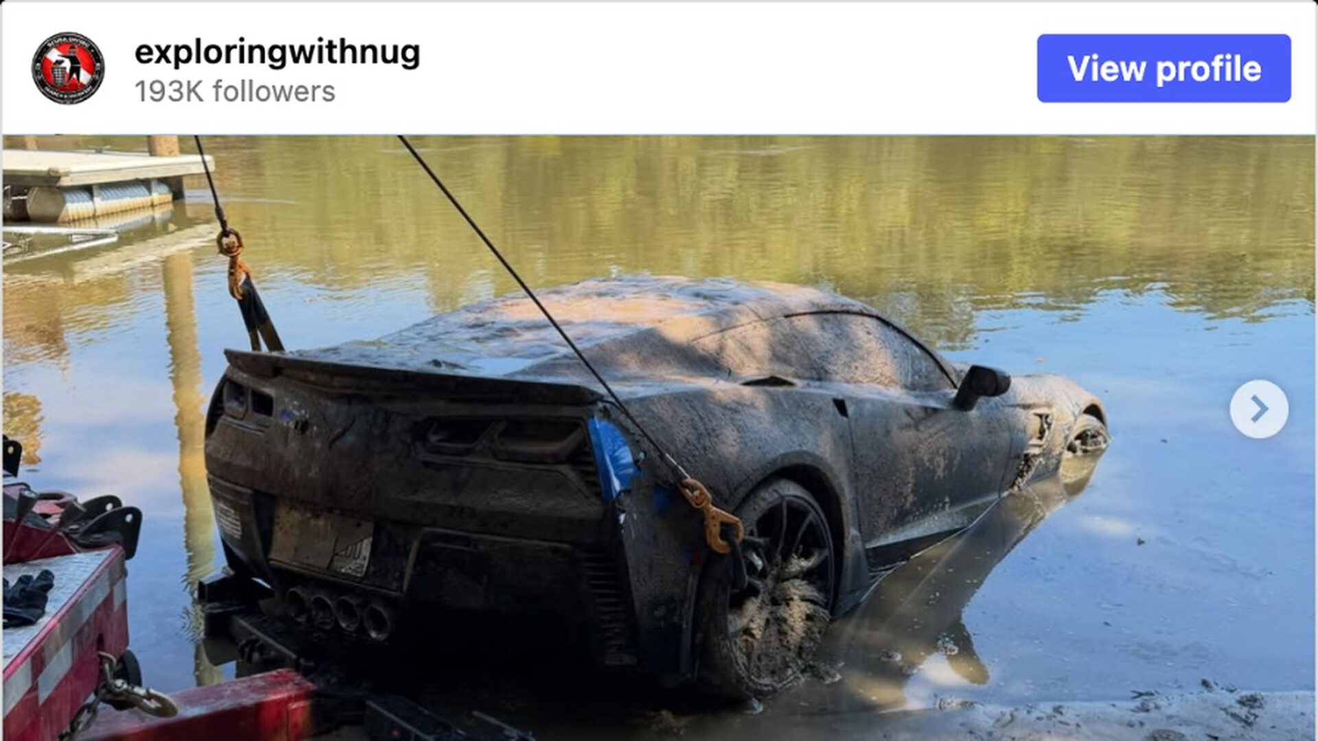 Mud-covered C7 Corvette Grand Sport on a tow cable at the edge of a Georgia river