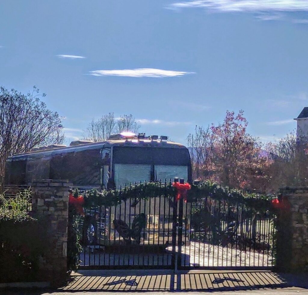 Dolly Parton's tour bus parked behind a gate at the DreamMore Resort in Pigeon Forge, Tennessee