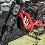 A red Sur-Ron electric dirt bike on display