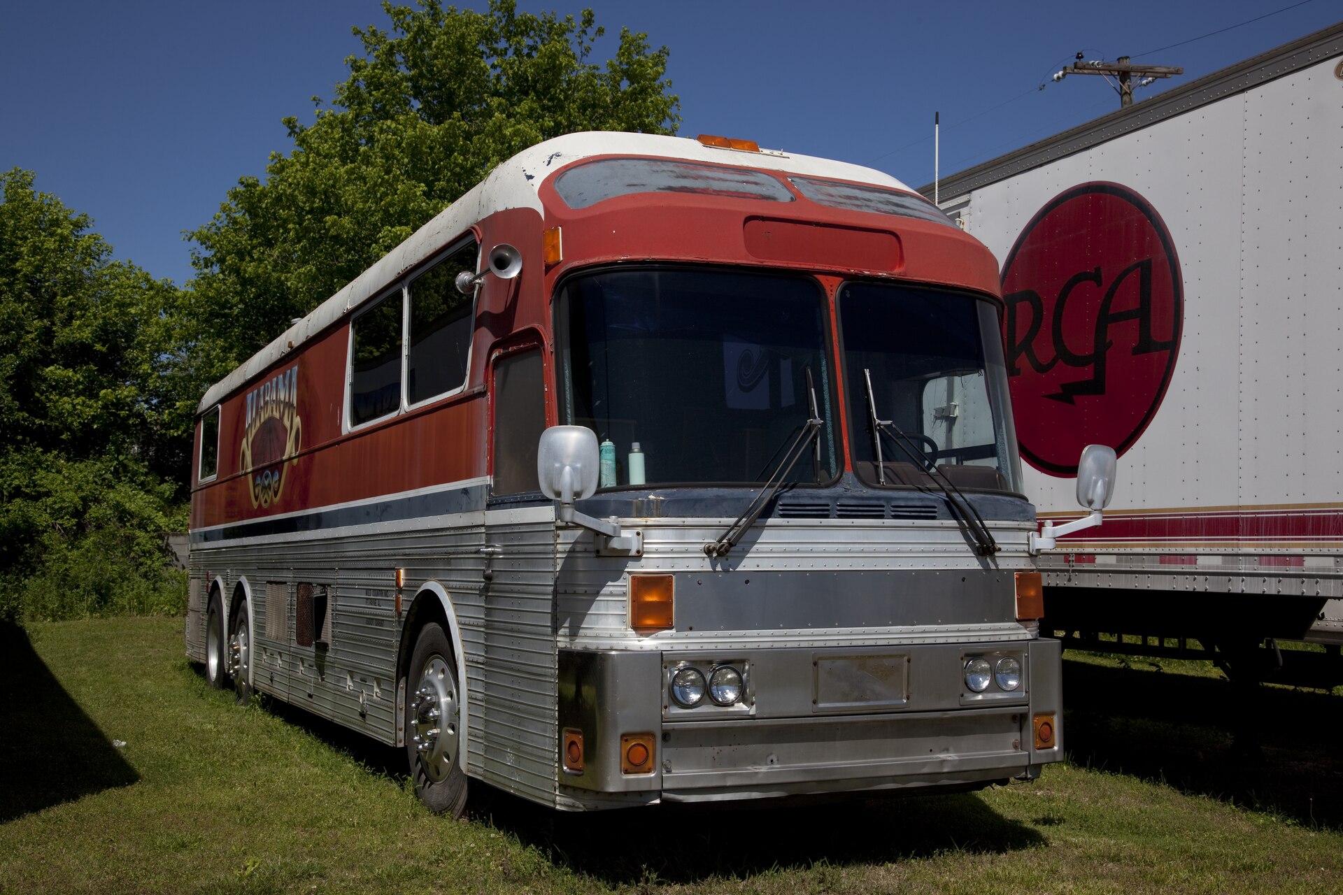 A red and silver Eagle tour bus used by the band Alabama, parked in Fort Payne, Alabama