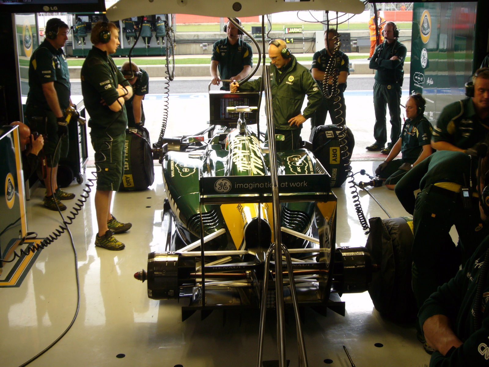 F1 team mechanics working in a garage