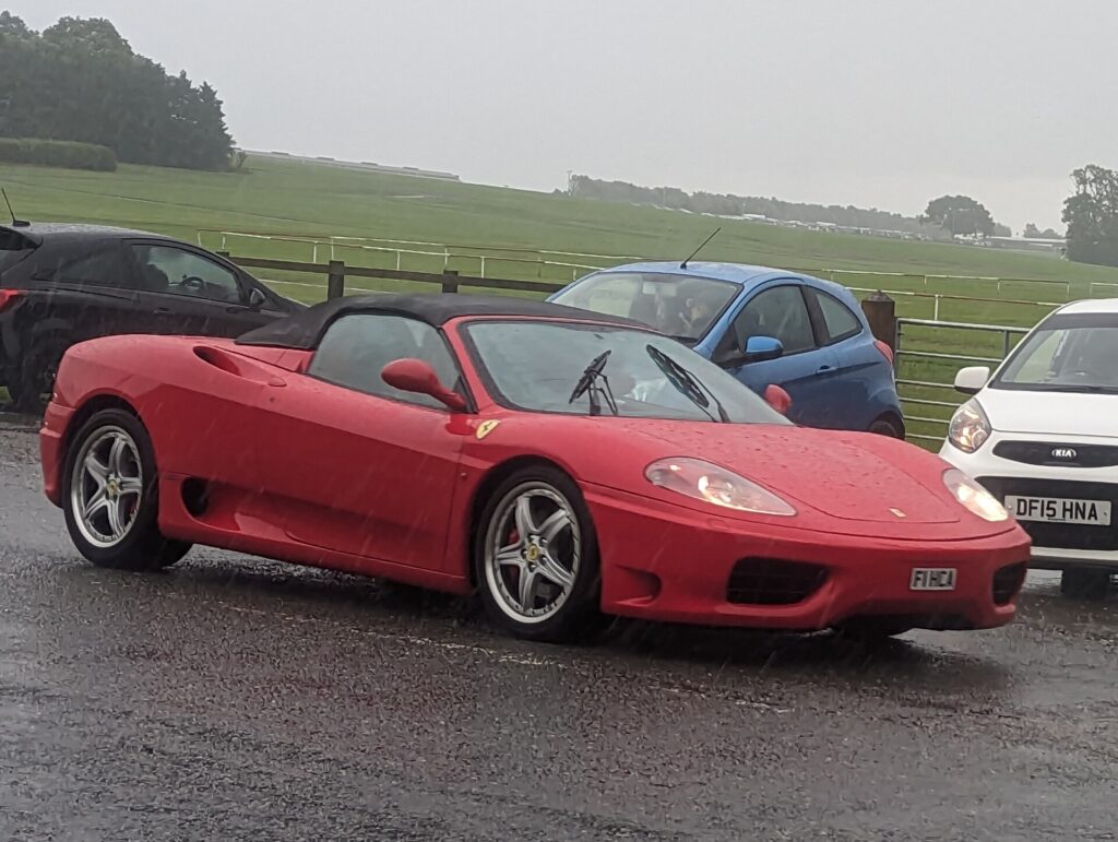 A red Ferrari 360 Spider with the top down