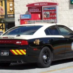 A Florida Highway Patrol Dodge Charger patrol car parked on a roadside