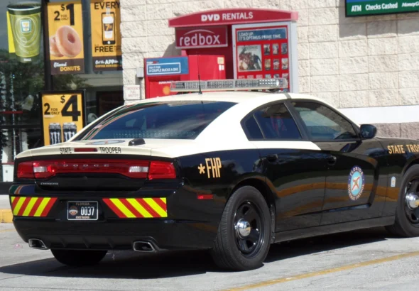 A Florida Highway Patrol Dodge Charger patrol car parked on a roadside