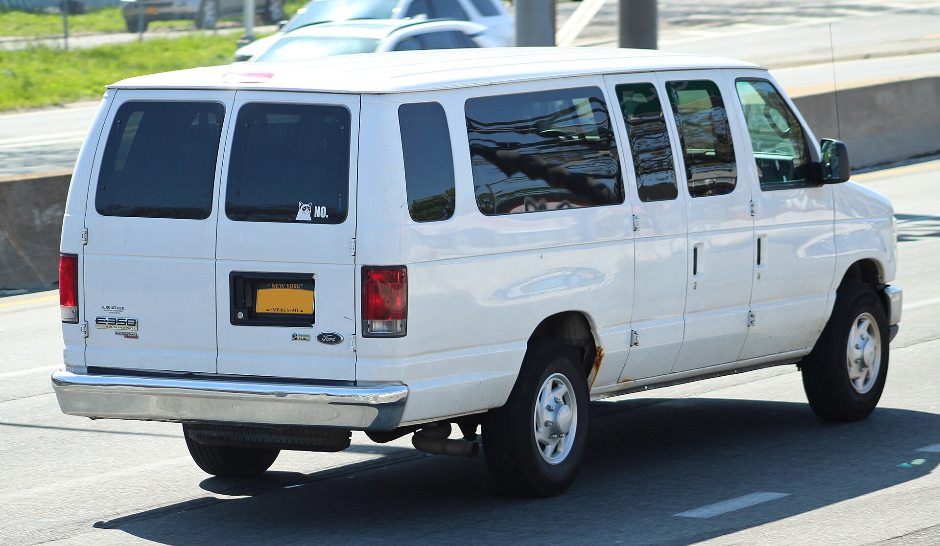 Rear three-quarter view of a Ford E-350 XLT Super Duty van