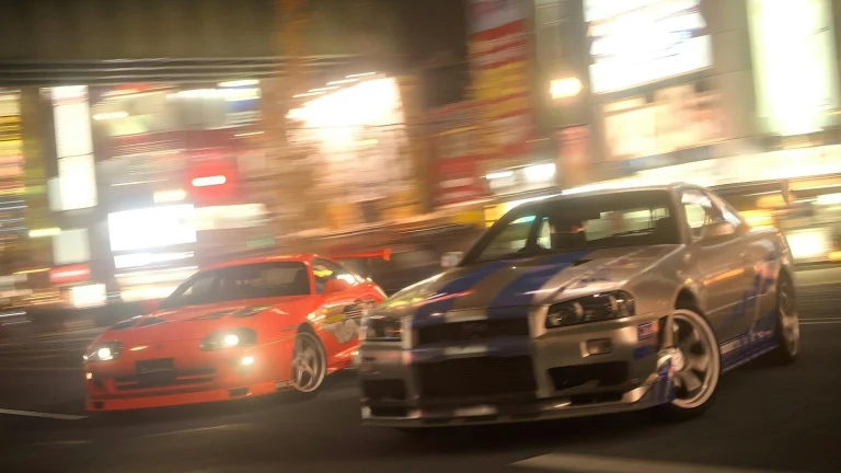 two cars driving down a city street at night