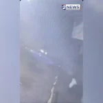 Surveillance video frame of a stolen car airborne next to a parked vehicle on Scott Street in Houston