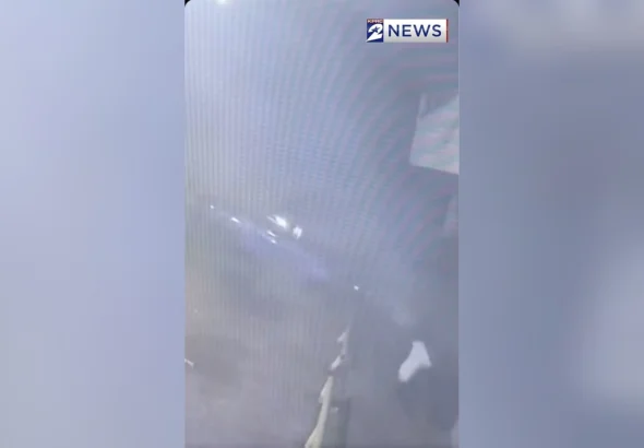 Surveillance video frame of a stolen car airborne next to a parked vehicle on Scott Street in Houston
