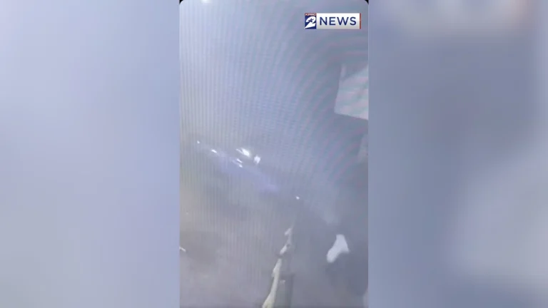 Surveillance video frame of a stolen car airborne next to a parked vehicle on Scott Street in Houston