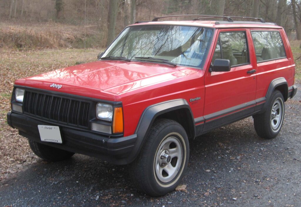 A red 1996 two-door Jeep Cherokee XJ
