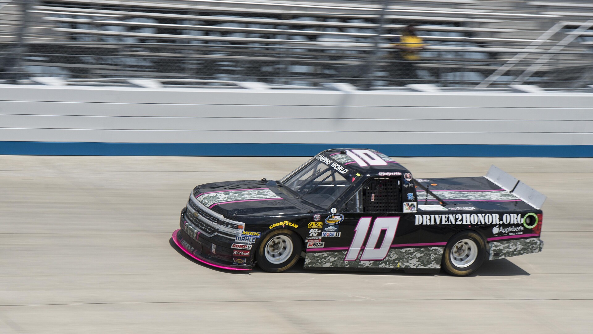 Jennifer Jo Cobb's No. 10 Chevrolet Truck Series pickup at speed during qualifying at Dover International Speedway in 2017