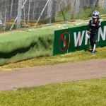 Kimi Antonelli walking along the barrier after retiring from the 2025 Emilia Romagna Grand Prix at Imola